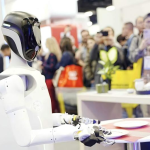 At a global tech expo, UniX AI's Wanda humanoid robot demonstrates precise manipulation, drawing a crowd of onlookers.