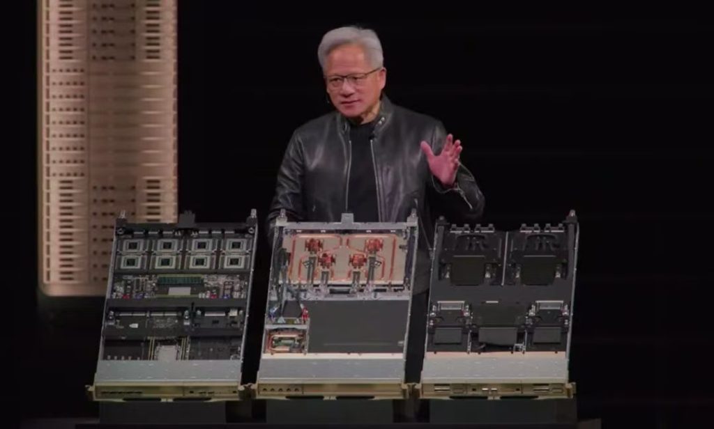 Jensen Huang speaking at GTC 2026, holding the Vera Rubin chip.