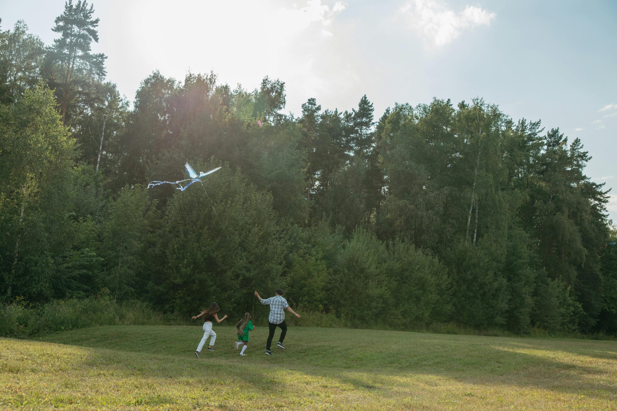 happy people flying kite in park