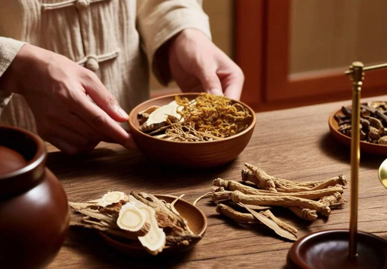 TCM practitioner blends herbal medicine, including dried roots and slices, essential for traditional therapy