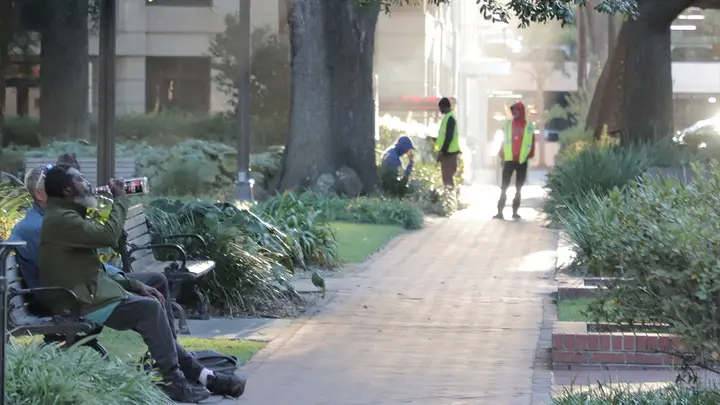Homeless people sit in Reynolds Square Oct. 21, 2025. (Richard Burkhart/Savannah Morning News/USA Today network via Imagn Images)