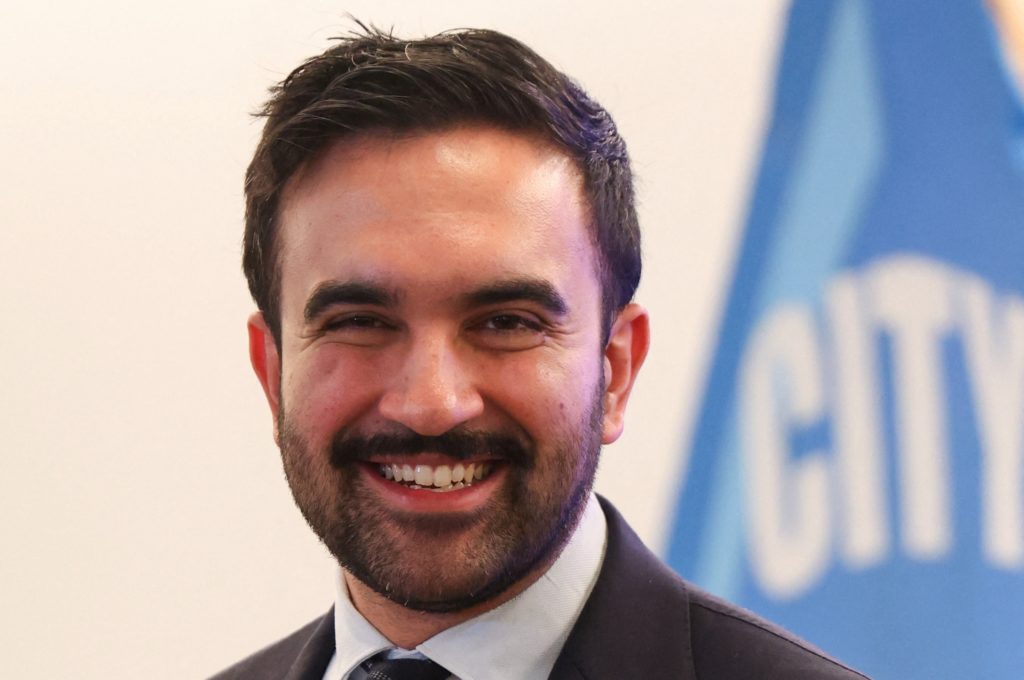 Portrait of Zohran Mamdani smiling at public event