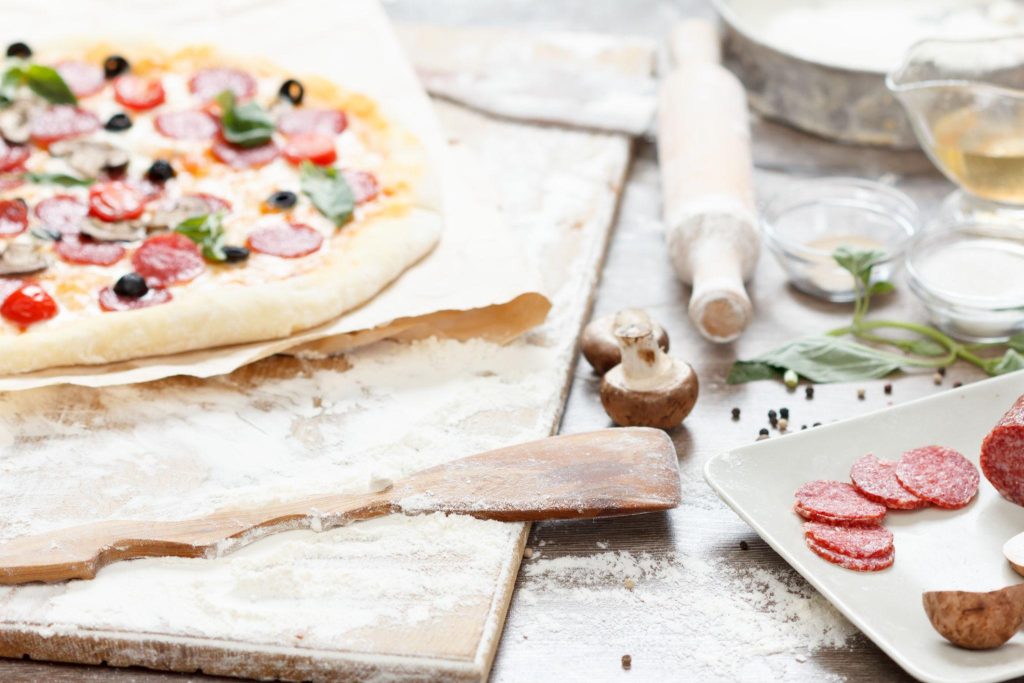 baked pepperoni pizza coming out of the oven