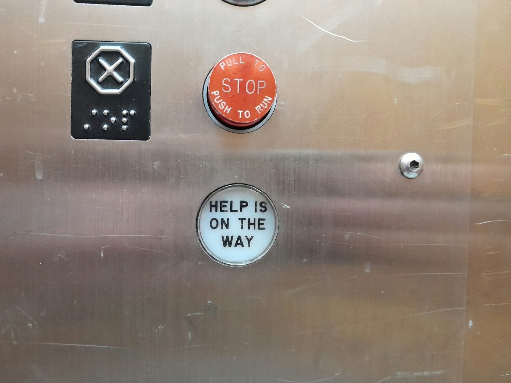 Emergency response safety in elevator showing emergency button and trapped passenger inside cabin