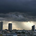 Typhoon storm clouds over city skyline